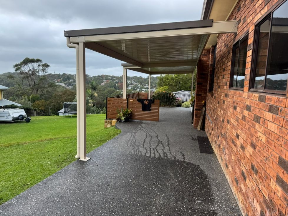 Outback Carport Next to a Brick House and Green Lawn — Narellan Home Improvement Centre In Liverpool, NSW