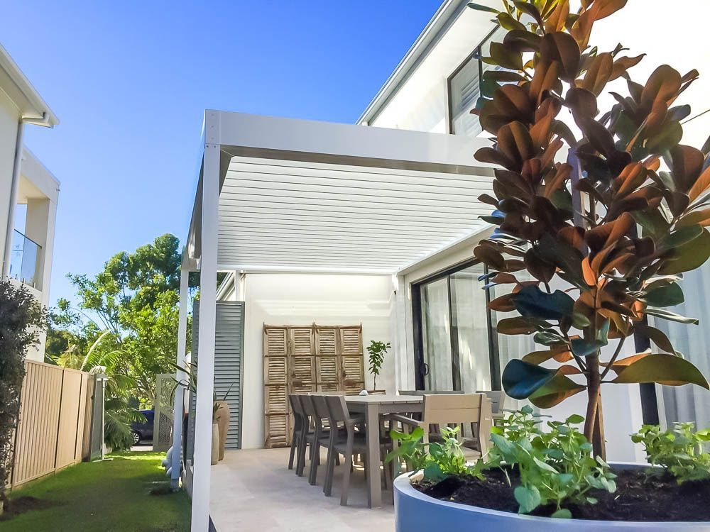 Patio With Dining Table Under White Pergola — Narellan Home Improvement Centre In Narellan, NSW