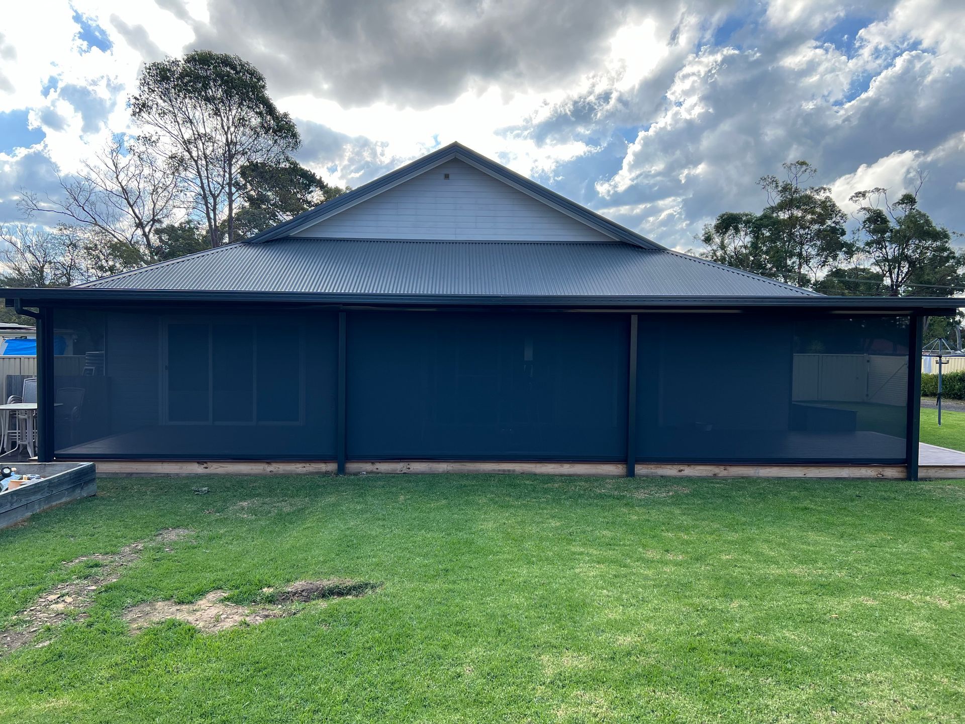 Backyard Patio With Green Fence and Pool Edge — Narellan Home Improvement Centre In Narellan, NSW