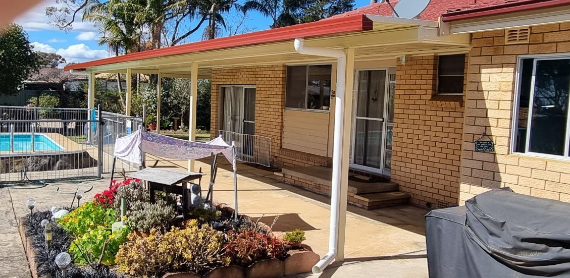 Backyard Patio With a Swimming Pool and Garden — Narellan Home Improvement Centre In Queanbeyan, NSW