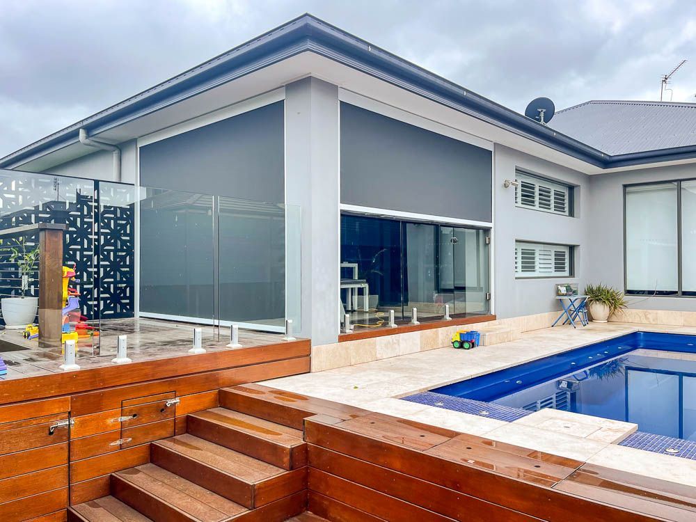 Modern Home With Gray Blinds Over Windows, Wood Deck, and Pool — Narellan Home Improvement Centre In Narellan, NSW