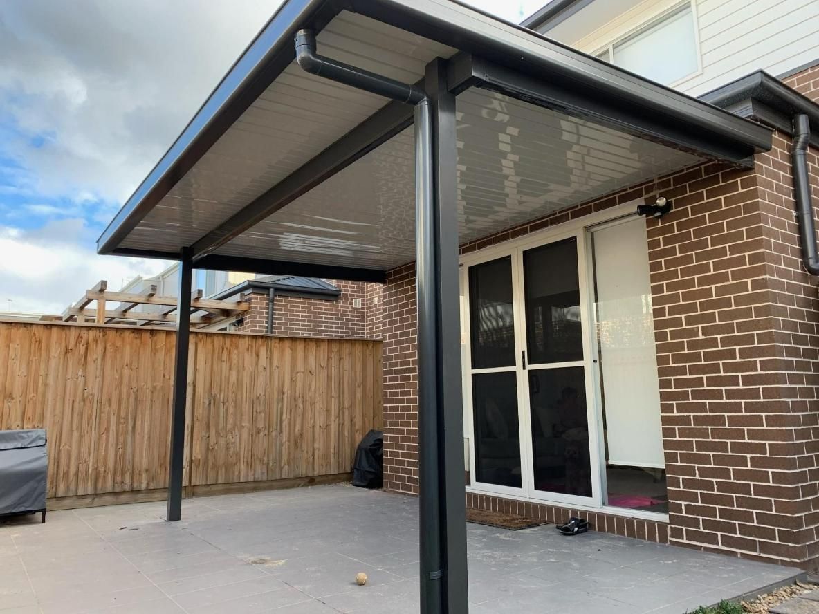 Black-framed Patio Cover Attached to a Brick House — Narellan Home Improvement Centre In Narellan, NSW