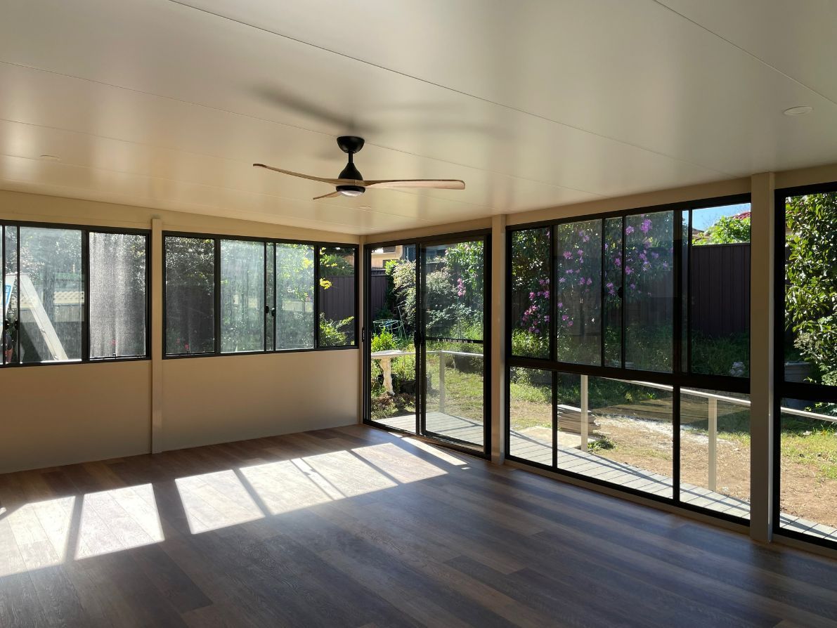 Sunroom With Large Windows, Wooden Floors, and a Ceiling Fan — Narellan Home Improvement Centre In Narellan, NSW