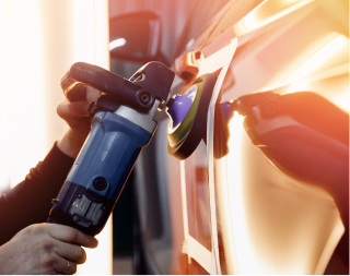 Person refueling a car with a blue gas nozzle at a sunlit gas station | Texas Carworx