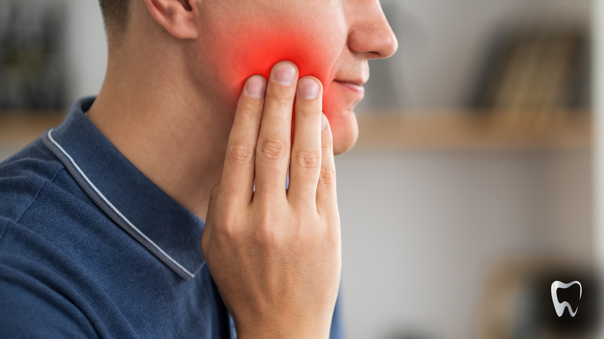 A man is holding his face in pain because of a toothache.