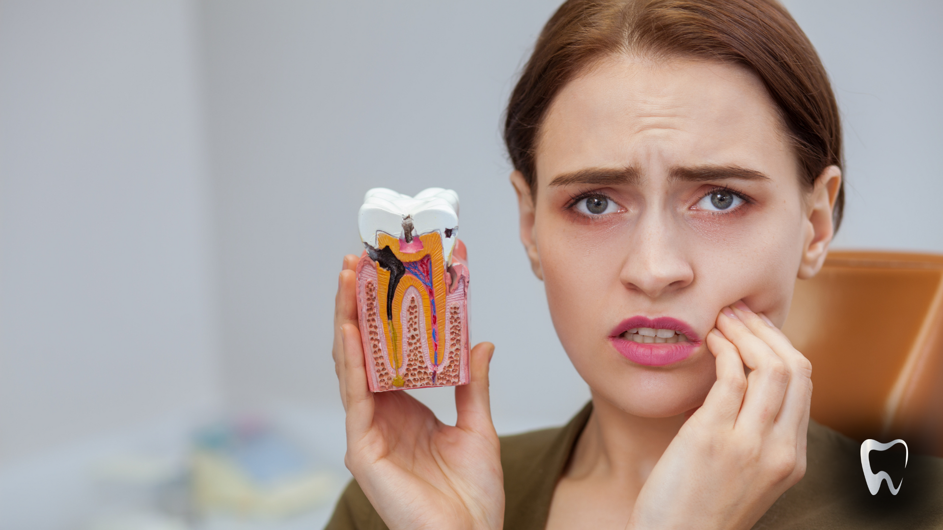 A person is looking at their teeth with a mirror.