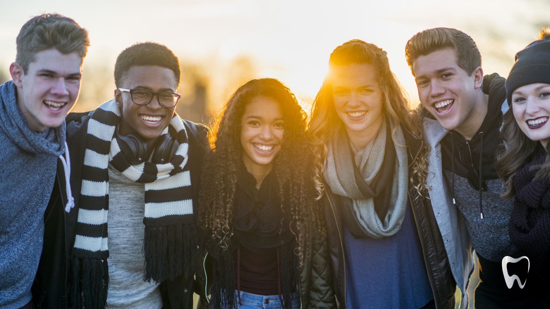 A group of young people are posing for a picture together.