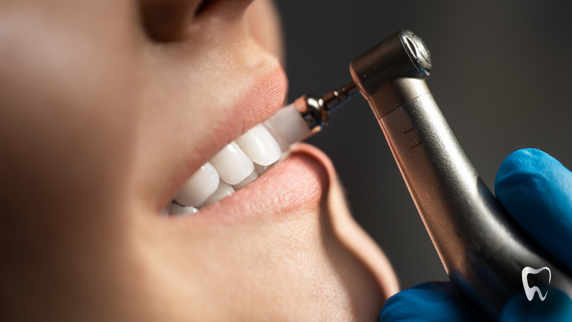 A woman is getting her teeth cleaned by a dentist.