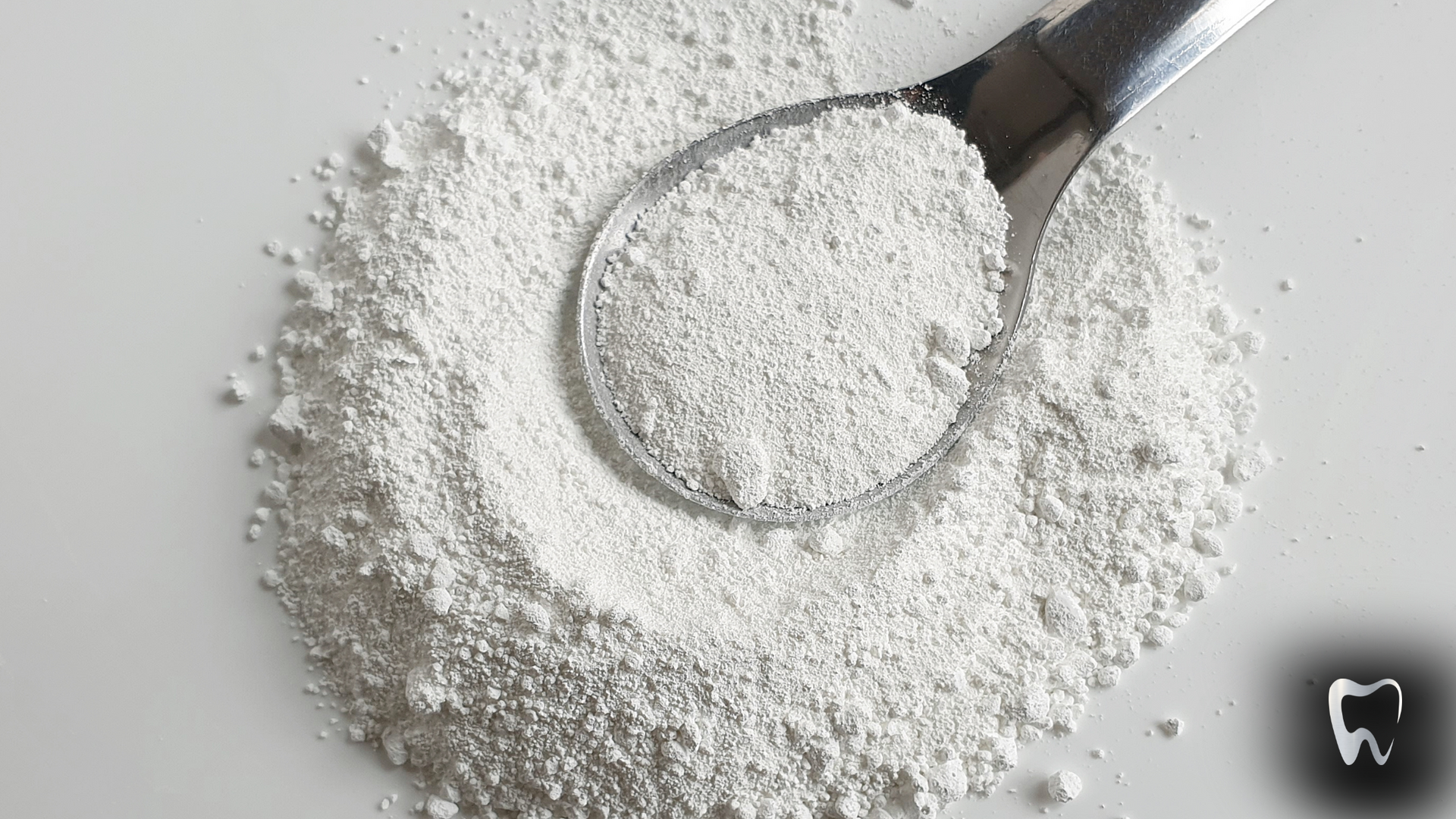 A pile of white powder with a spoon in it.