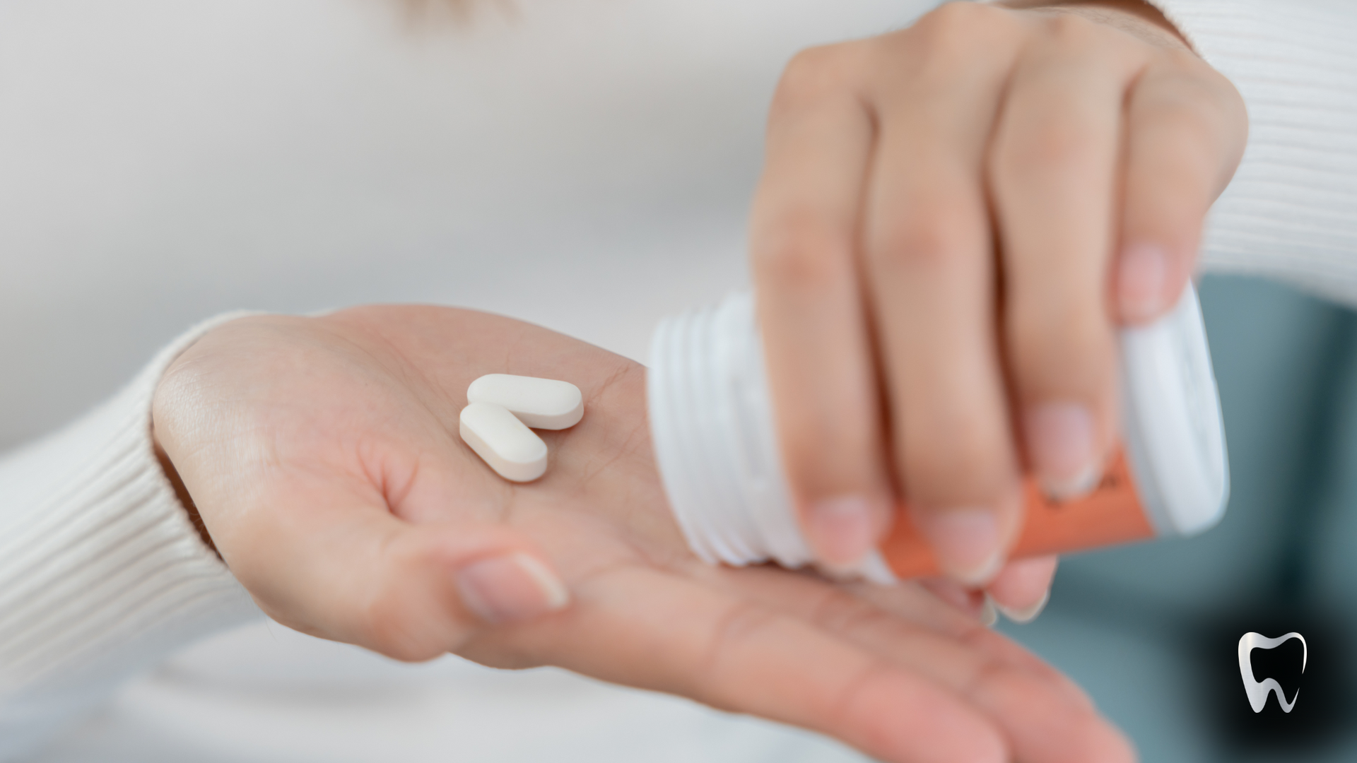 A person is pouring pills from a bottle into their hand.