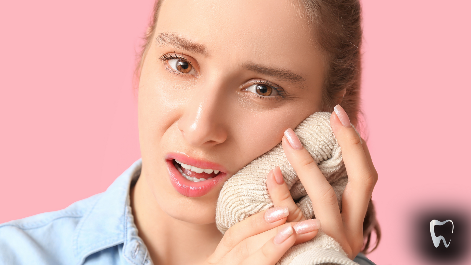 A woman is holding a towel over her mouth.