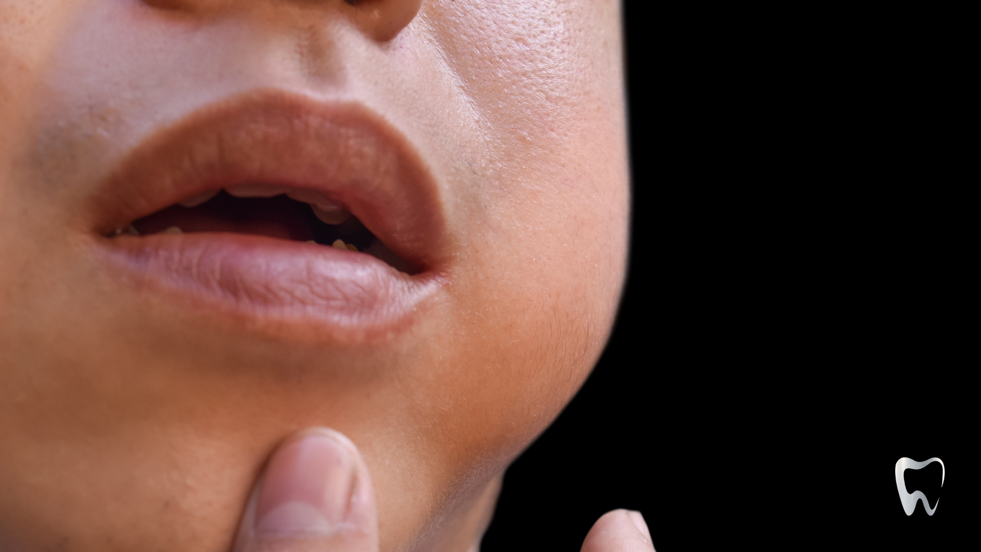 A close up of a person 's mouth with a black background.