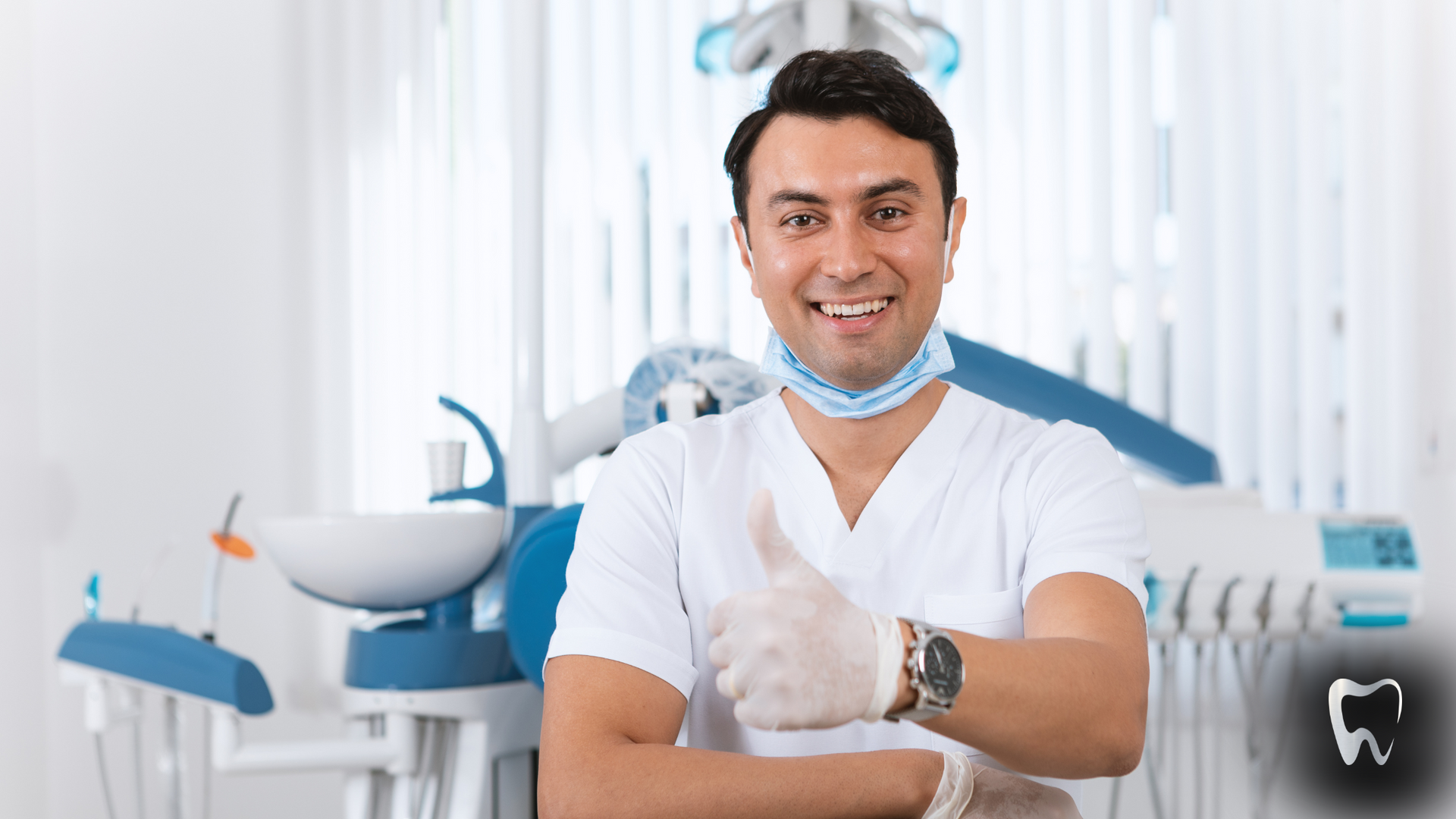 A dentist is giving a thumbs up in a dental office.