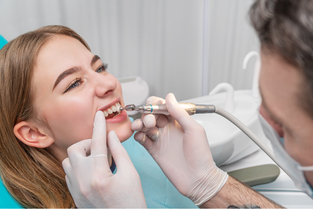 A woman is having her teeth examined by a dentist.