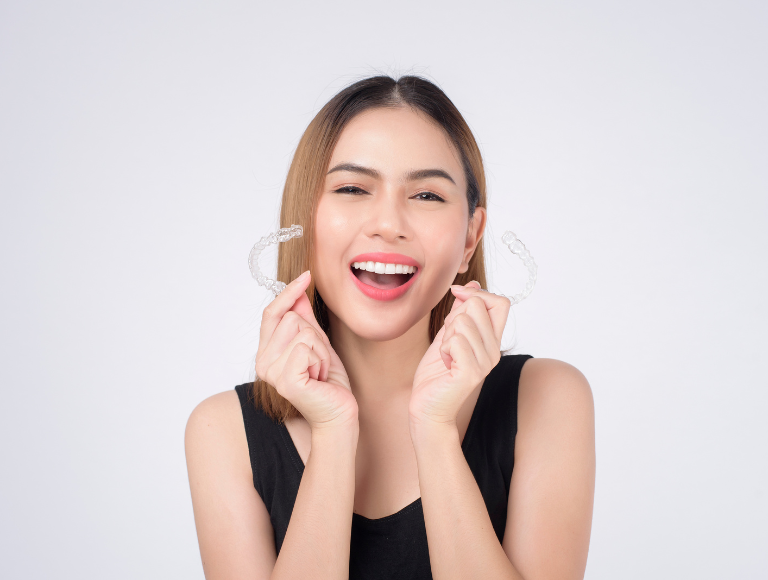 A dentist is examining a woman 's teeth in a dental office.