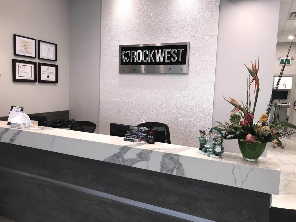 The front desk of a dental office with flowers on it.