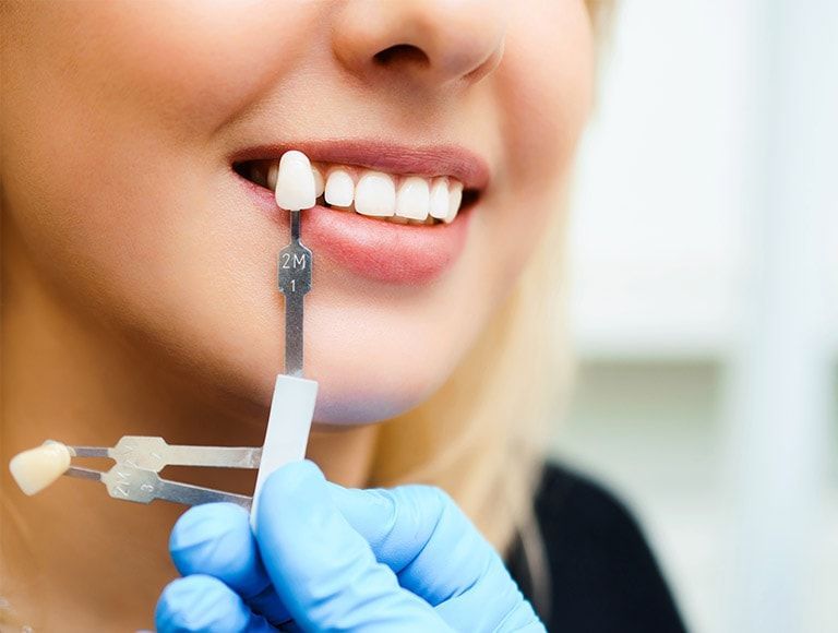 A woman is getting her teeth examined by a dentist.