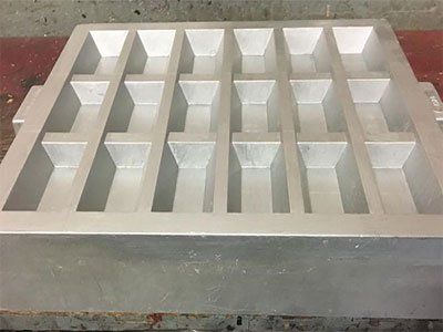 A metal tray with holes in it is sitting on a table.