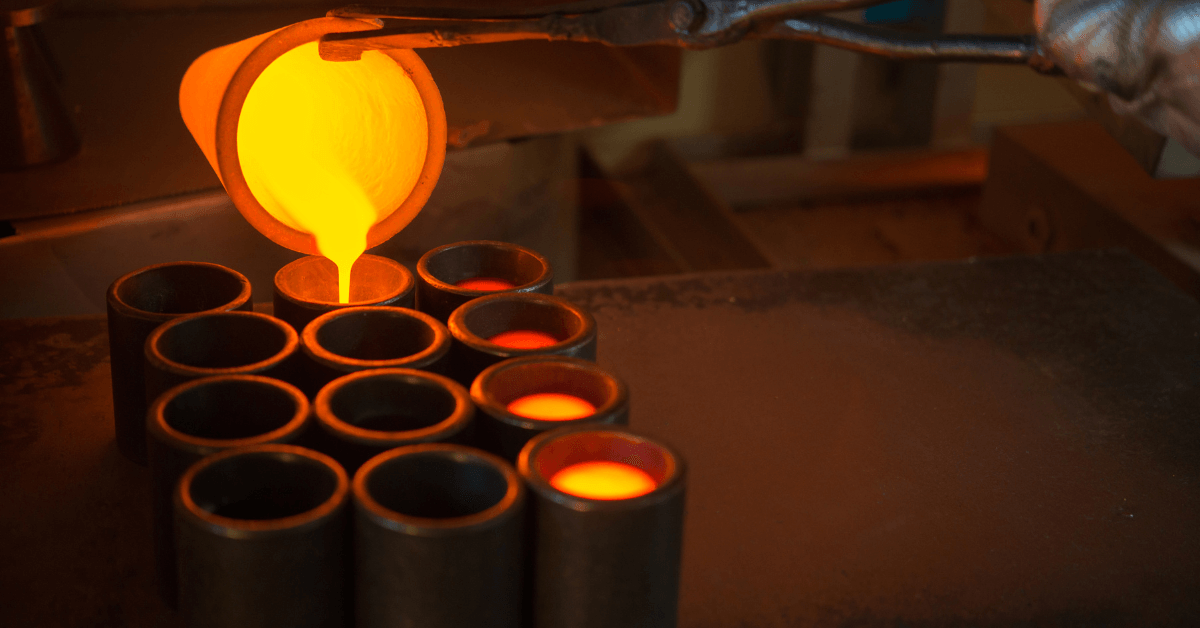 A person is pouring molten metal into a stack of cups.
