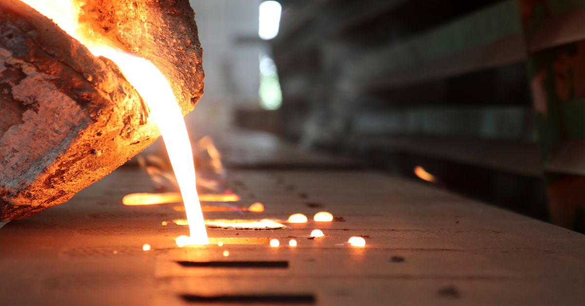 A close up of molten metal being poured into a mold.