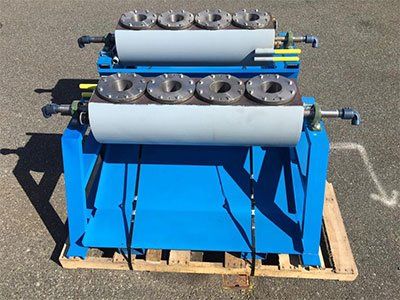 A blue and white machine is sitting on a wooden pallet