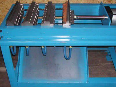 A blue machine is sitting on top of a wooden table.