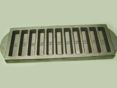 A metal tray with holes in it is sitting on a table.