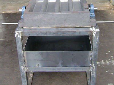 A metal box is sitting on top of a metal stand.