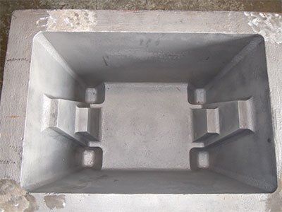 A metal container is sitting on top of a concrete surface.