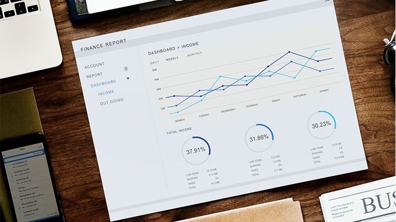 A paper with a graph on it is sitting on a wooden table.