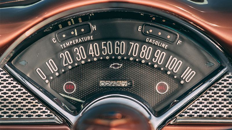 A close up of a gauge on the dashboard of a car.