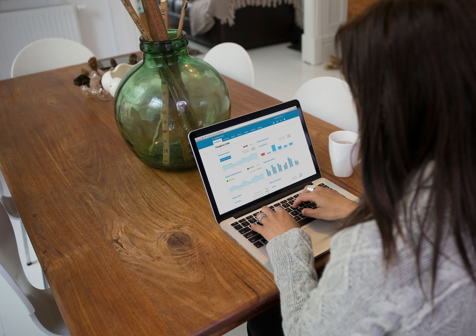 A businesswoman accesses Xero accounting software on her laptop at home