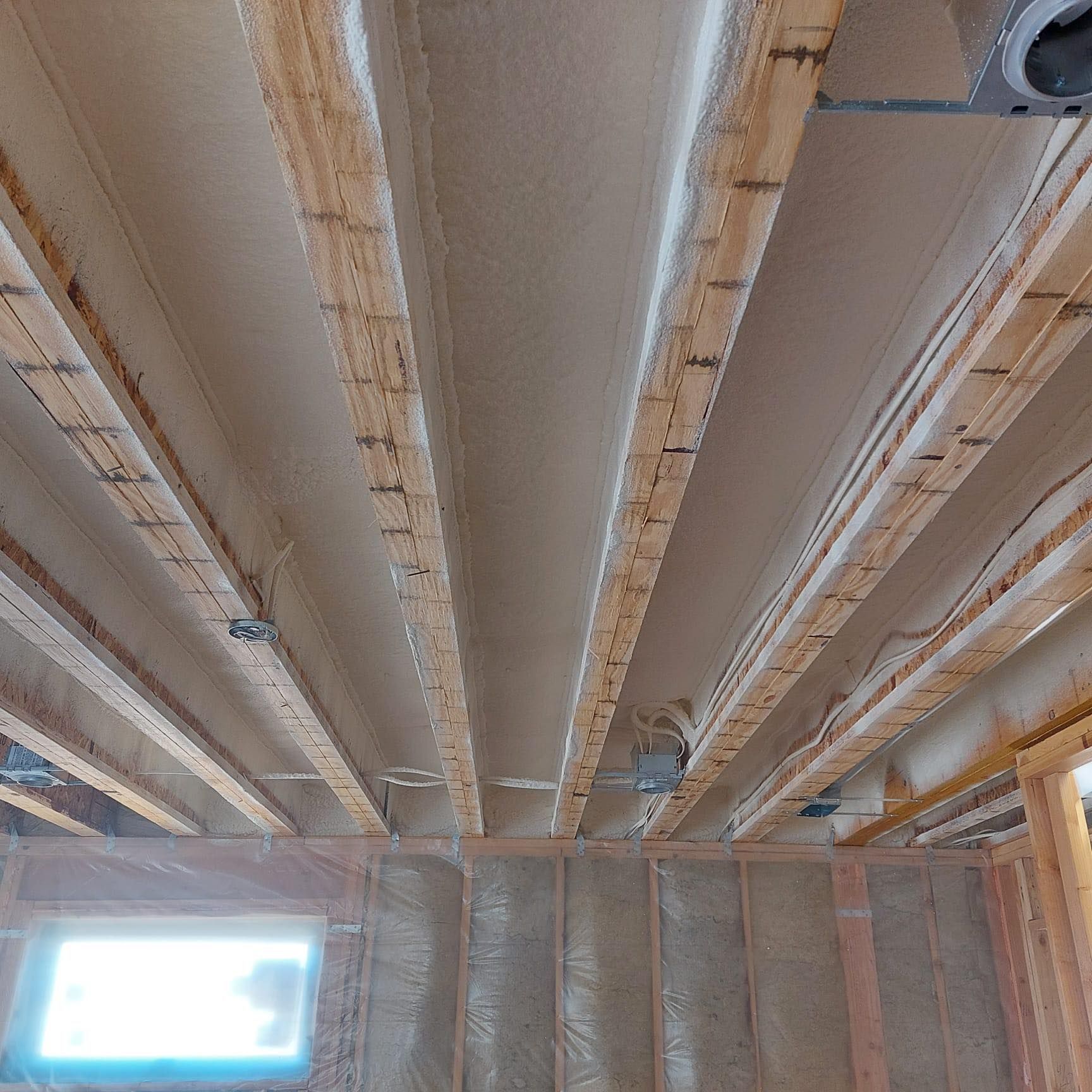A ceiling with a lot of wooden beams and a window