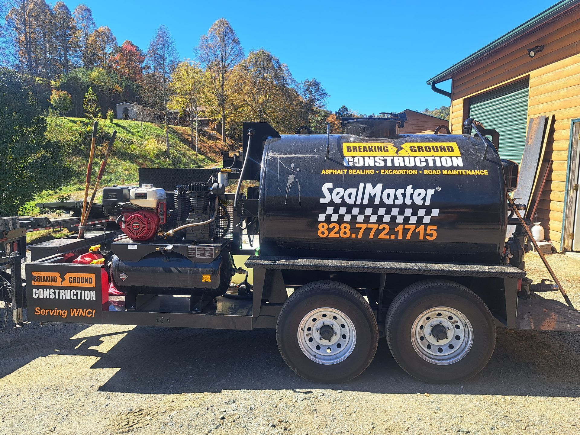 A seal master truck is parked in front of a building