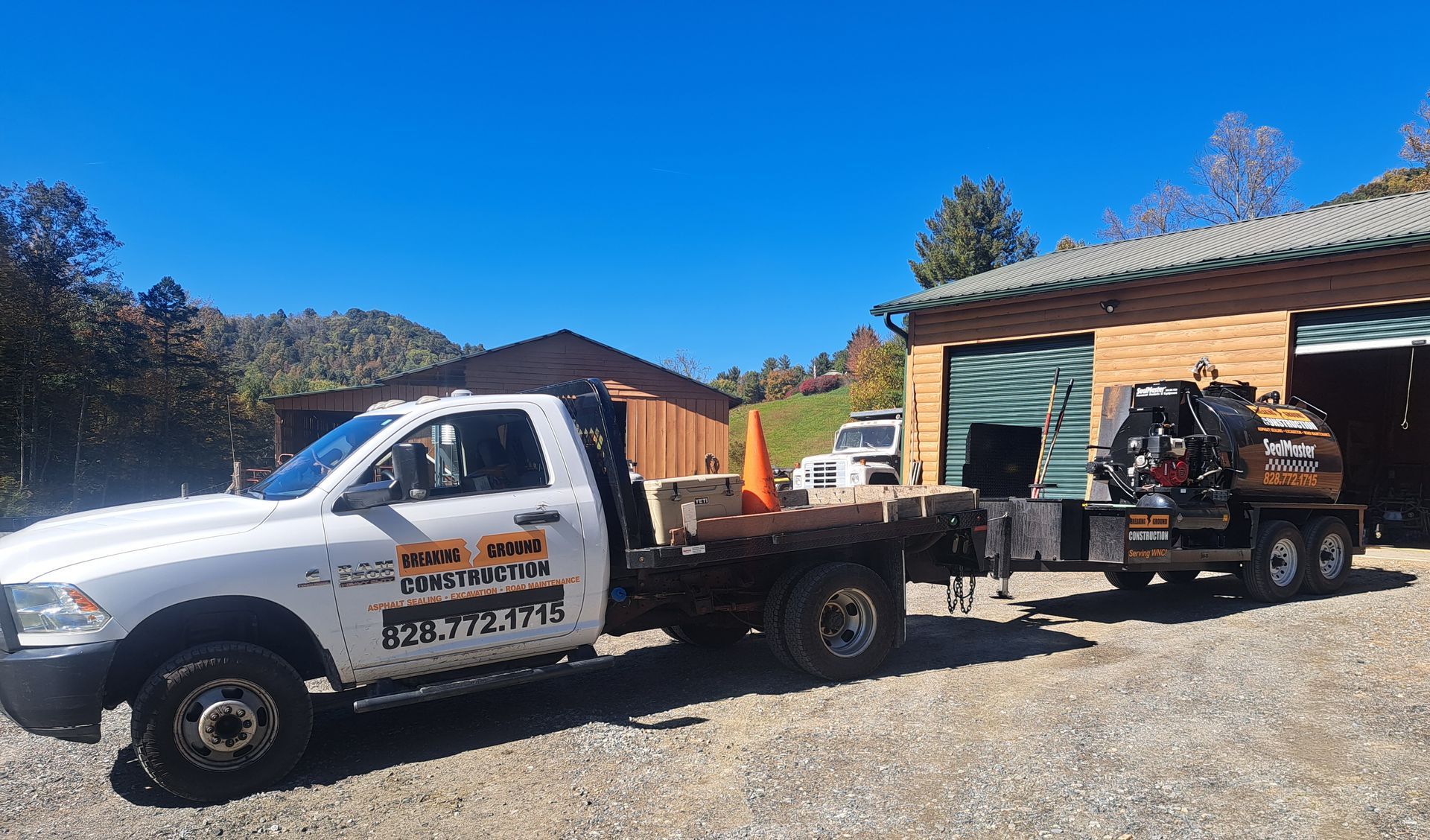 A white truck is parked in front of a building
