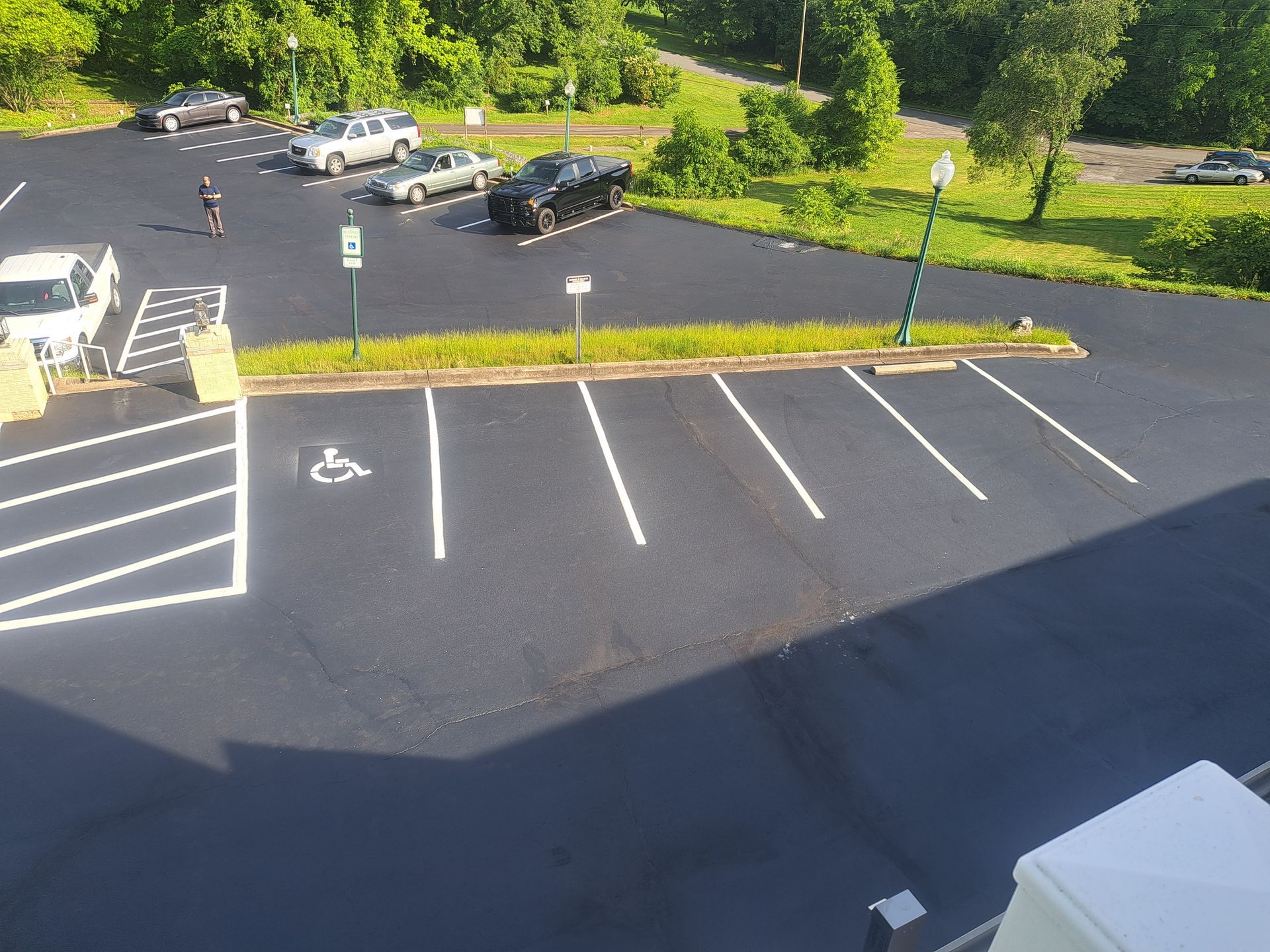 An aerial view of a parking lot with cars parked in it
