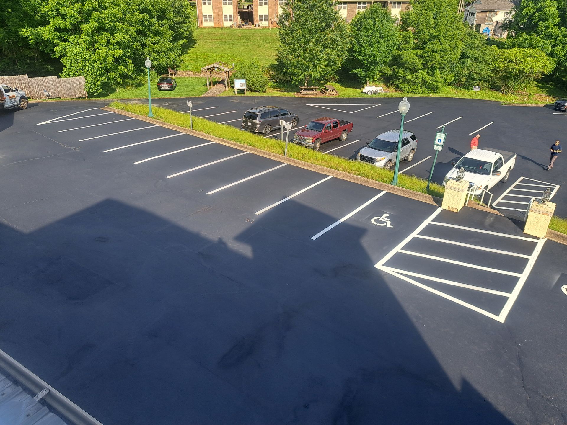 An aerial view of a parking lot with cars parked in it