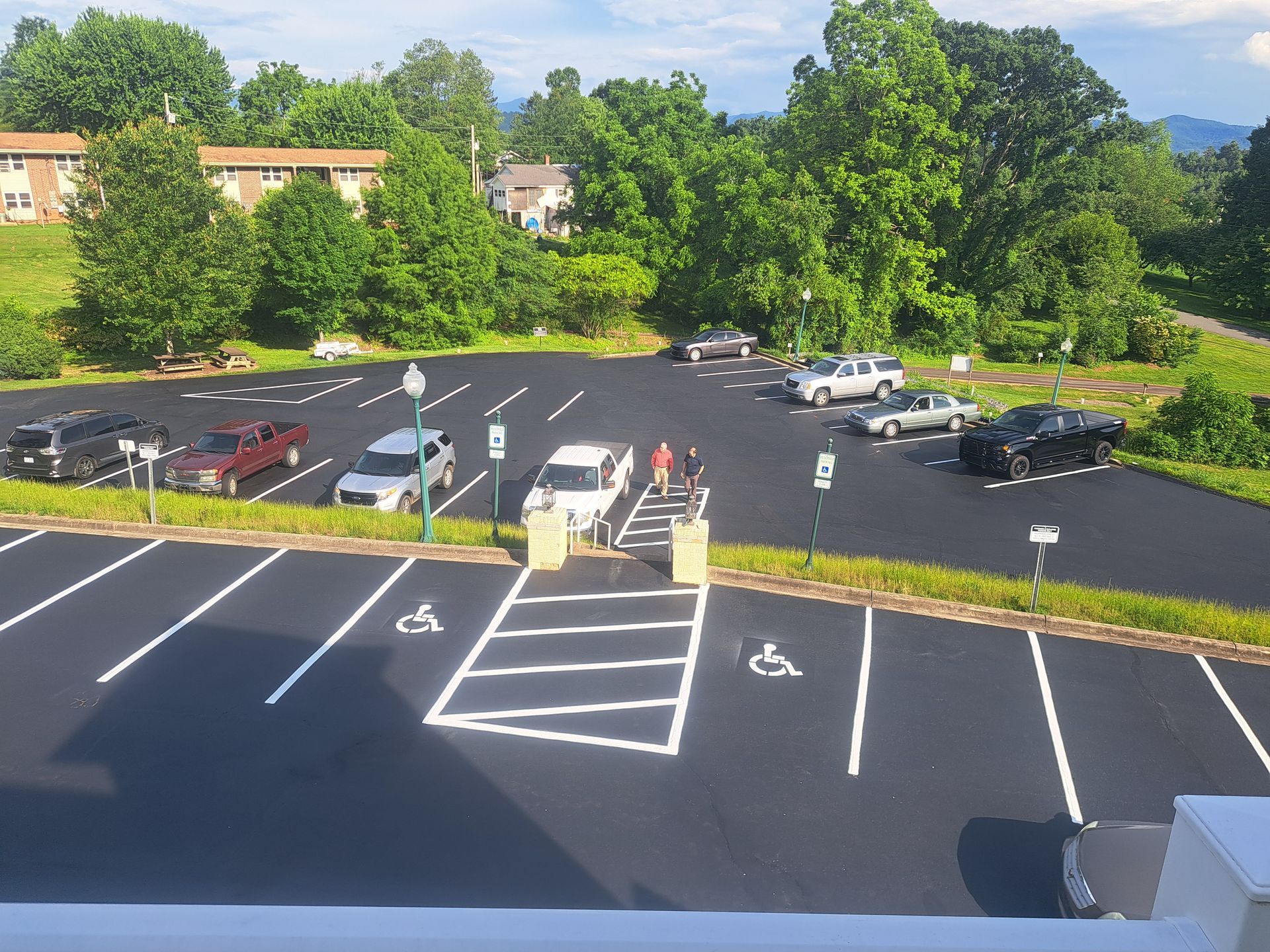 An aerial view of a parking lot with cars parked in it