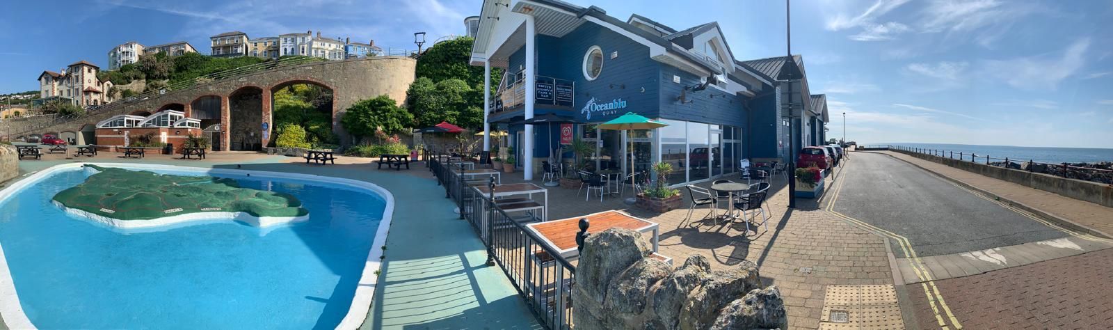 Besty & Spinky's at Ocean Quay on Ventnor Seafront showing outside tables on the terrace and the famous Ventnor paddling pool