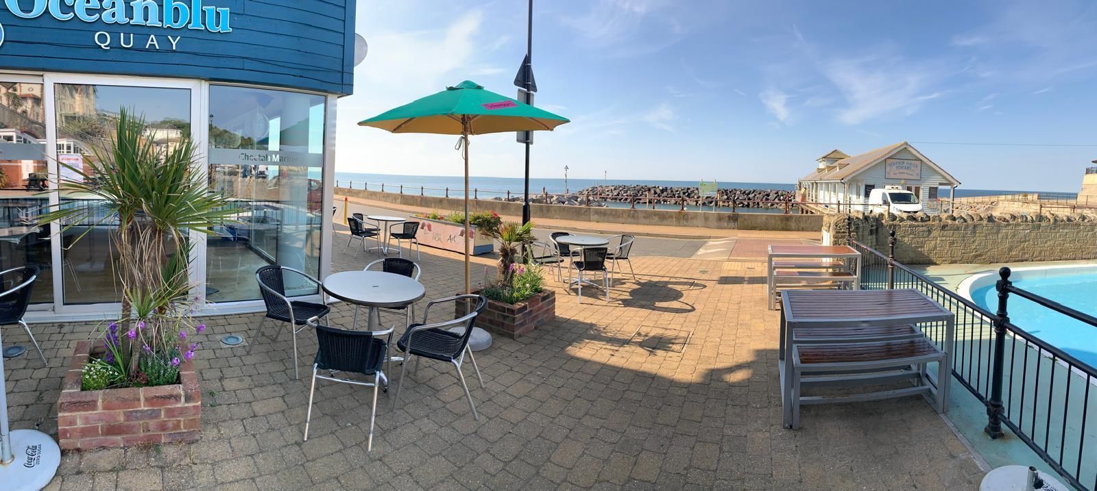 Besty & Spinky's at Ocean Quay on Ventnor Seafront showing outside tables on the terrace and the famous Ventnor paddling pool