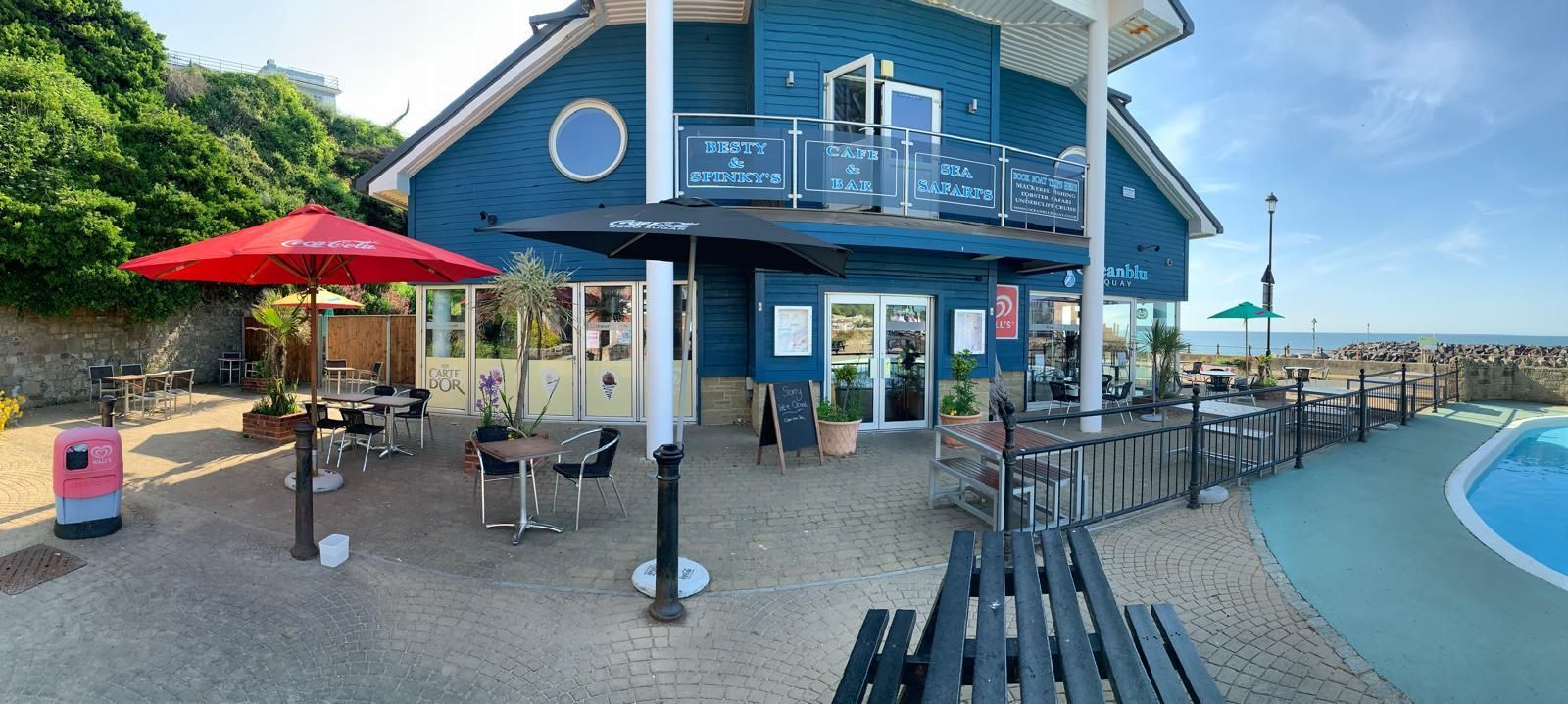 Besty & Spinky's at Ocean Quay on Ventnor Seafront showing outside tables on the terrace and the famous Ventnor paddling pool