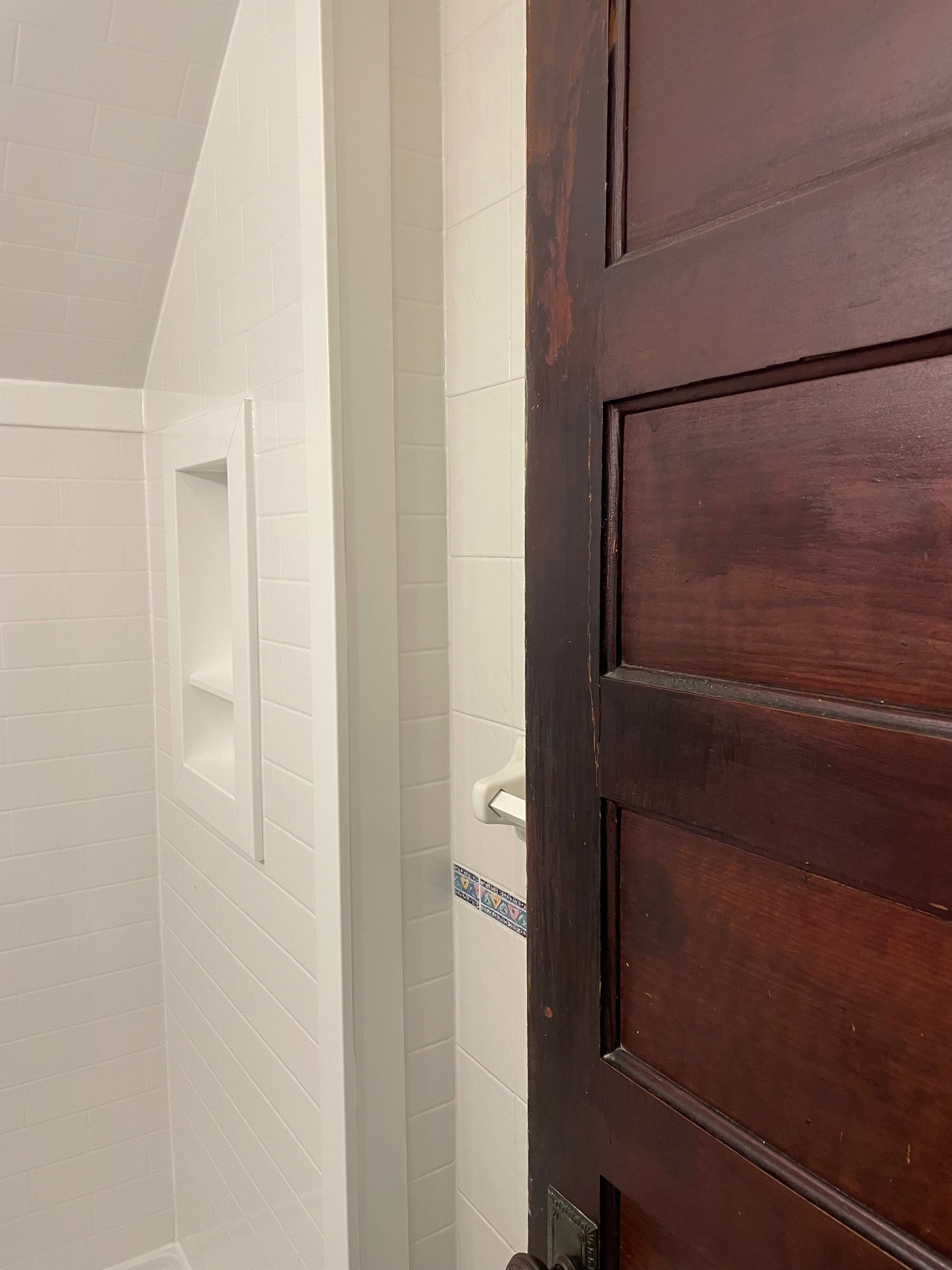A bathroom with a shower and a window.