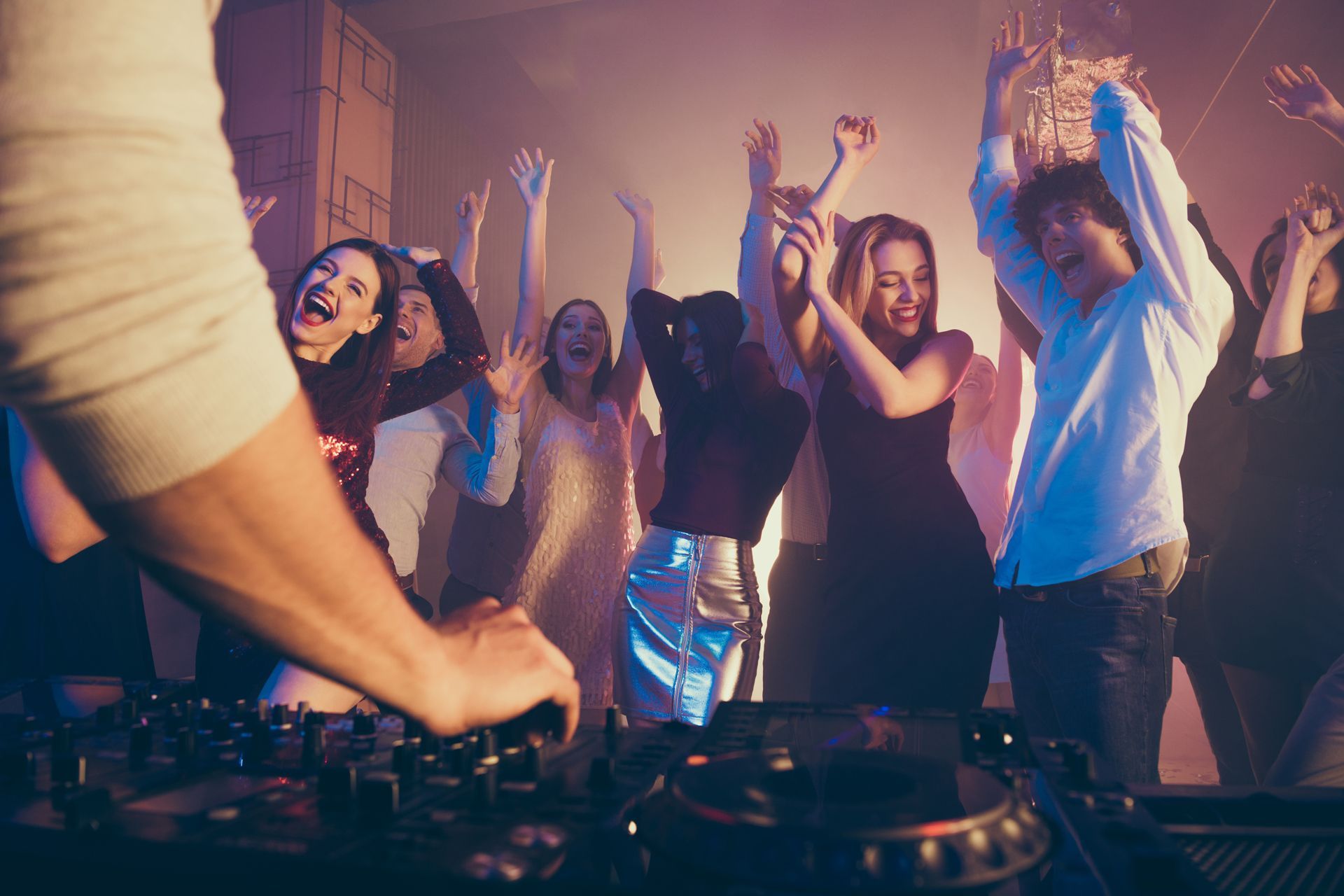 DJ at a party, playing music.