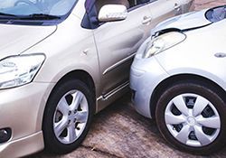 Two cars are parked next to each other on the side of the road.