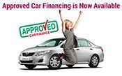 A woman is jumping in the air in front of an approved car.