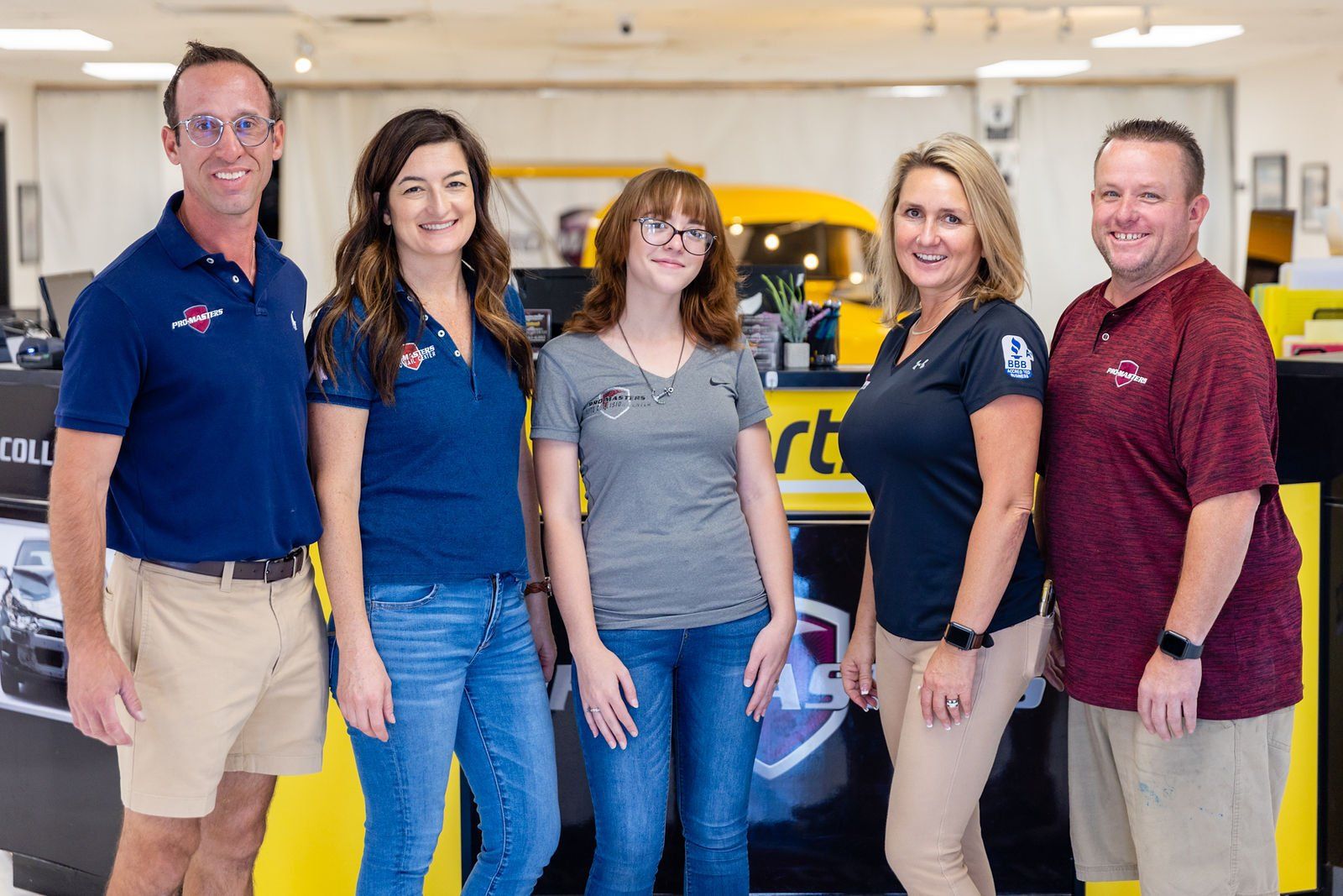 A group of people are posing for a picture in a store.