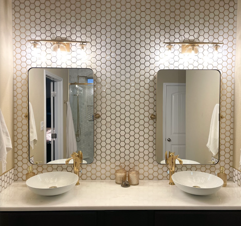 A bathroom with two sinks and two mirrors.