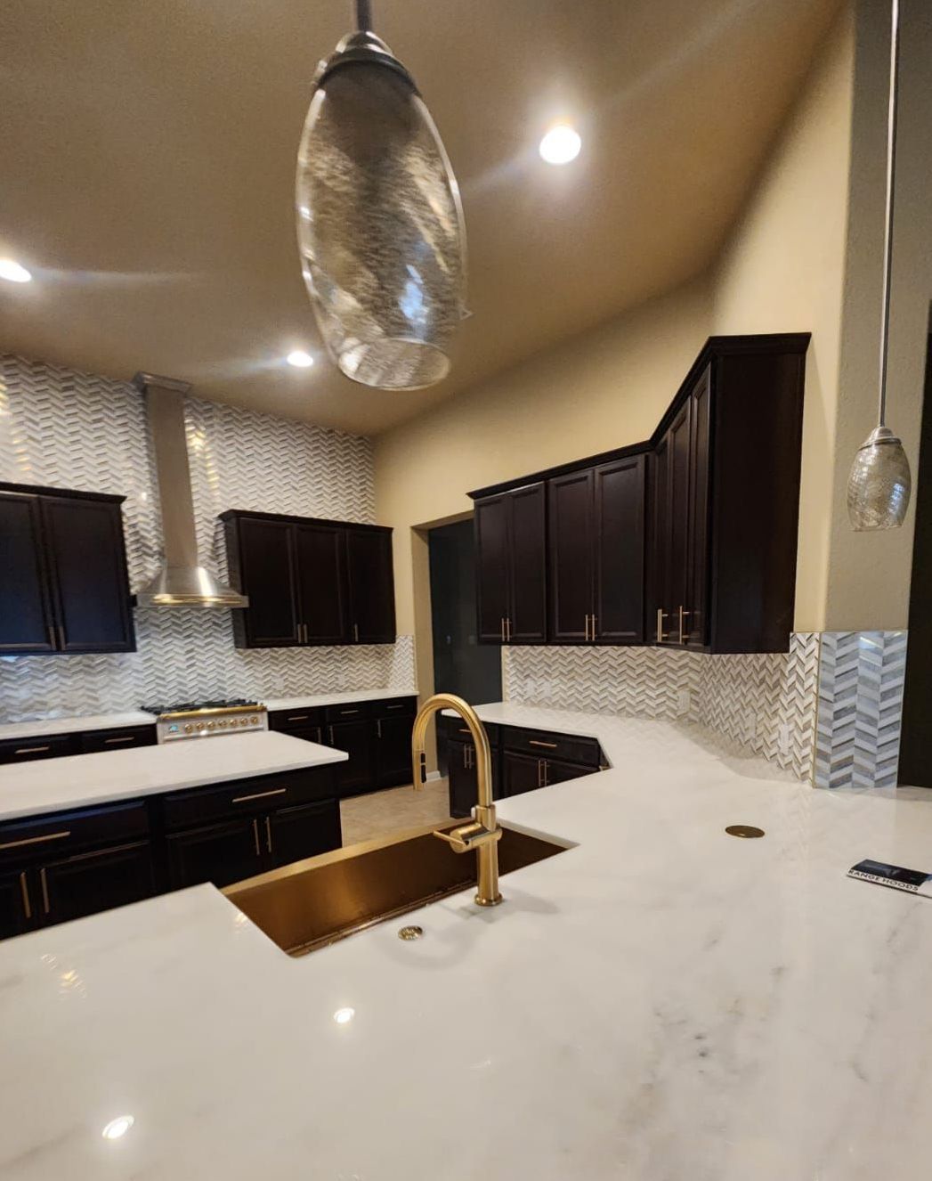 A kitchen with a sink and a light hanging from the ceiling