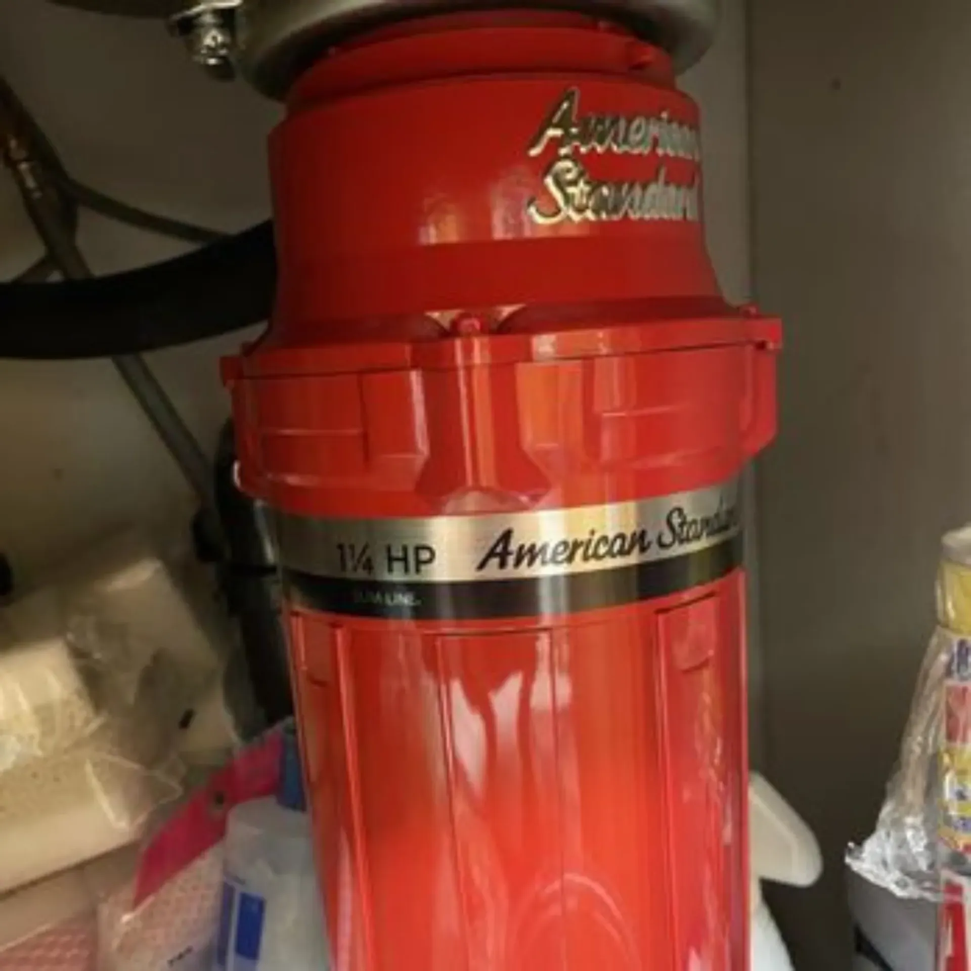 GTZ Plumbing Service LLC - A red american standard garbage disposal is under a sink