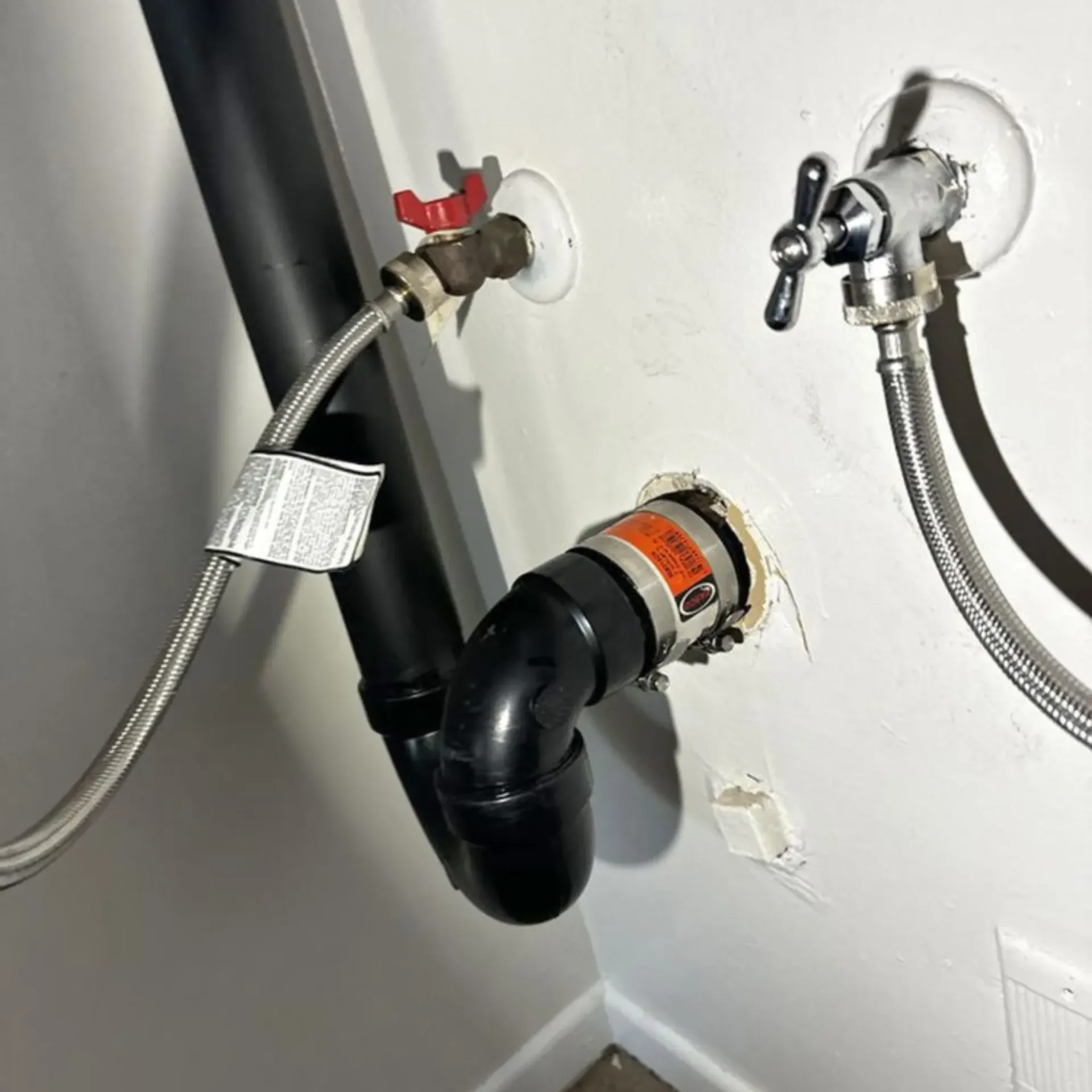 GTZ Plumbing Service LLC - A close up of a pipe with a hose attached to it